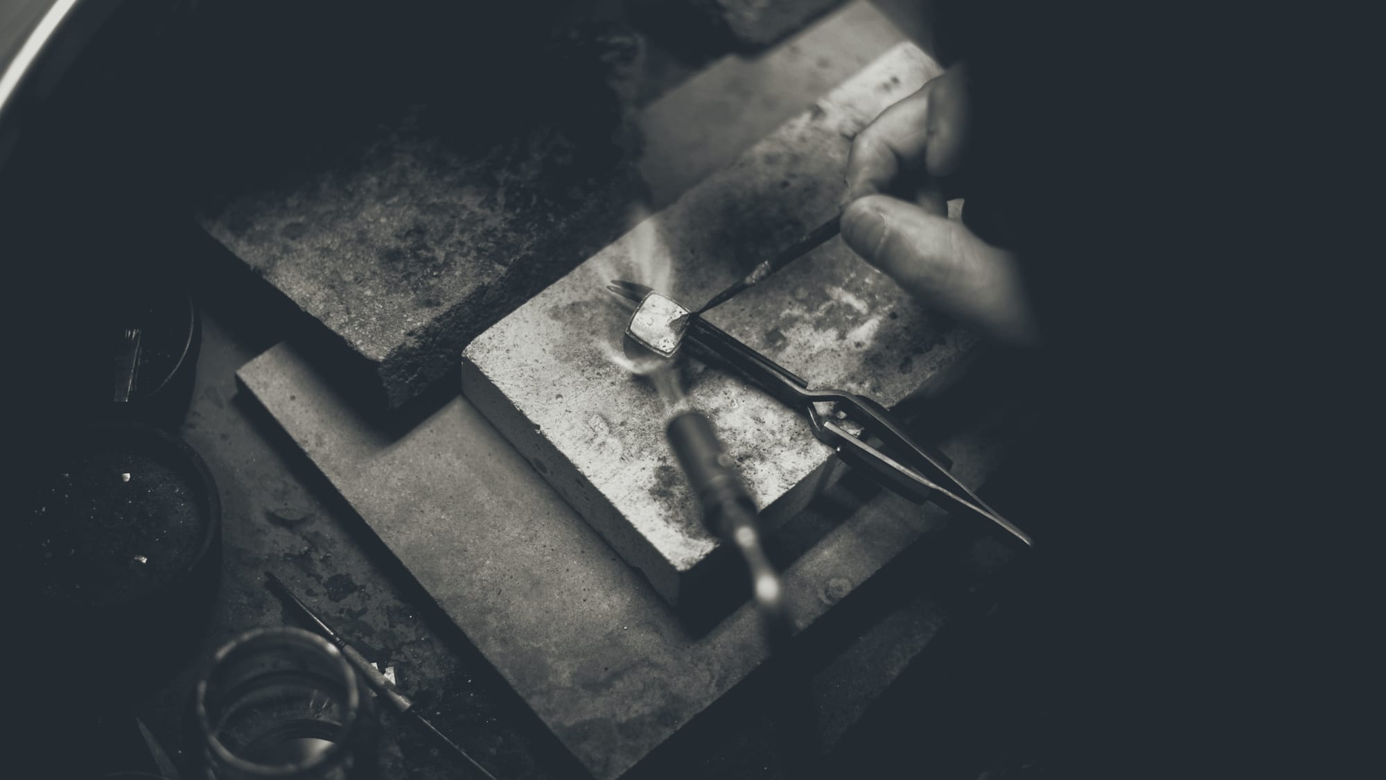 A torch flame at the jeweler's bench during a repair